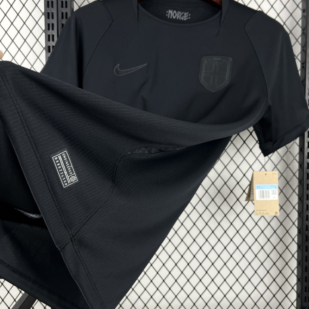 Norway away fan soccer jersey close-up: dark navy chest logos and embroidered shield