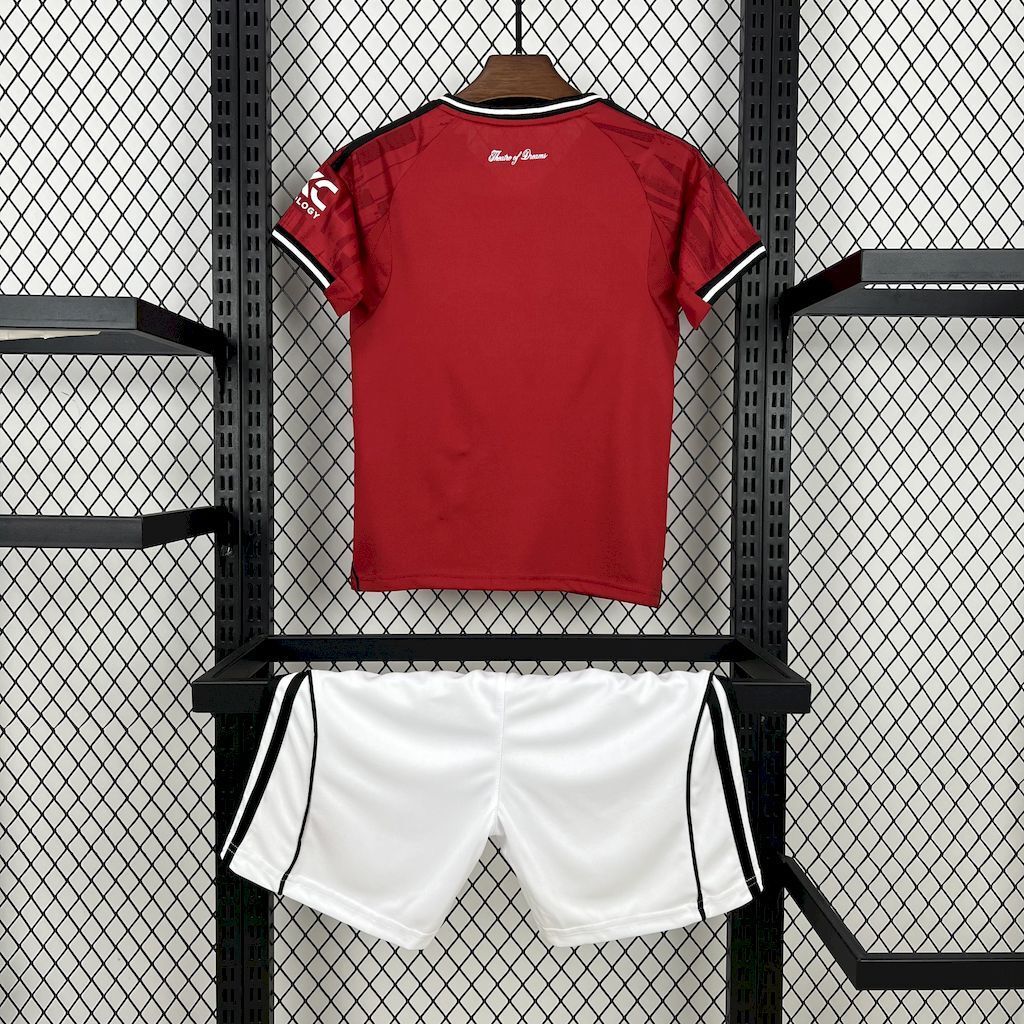 Kids red home football shirt back view with white shorts, black side stripes