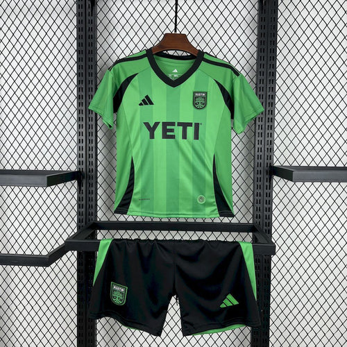 Kids green soccer jersey and black-trim shorts with YETI logo and team crest
