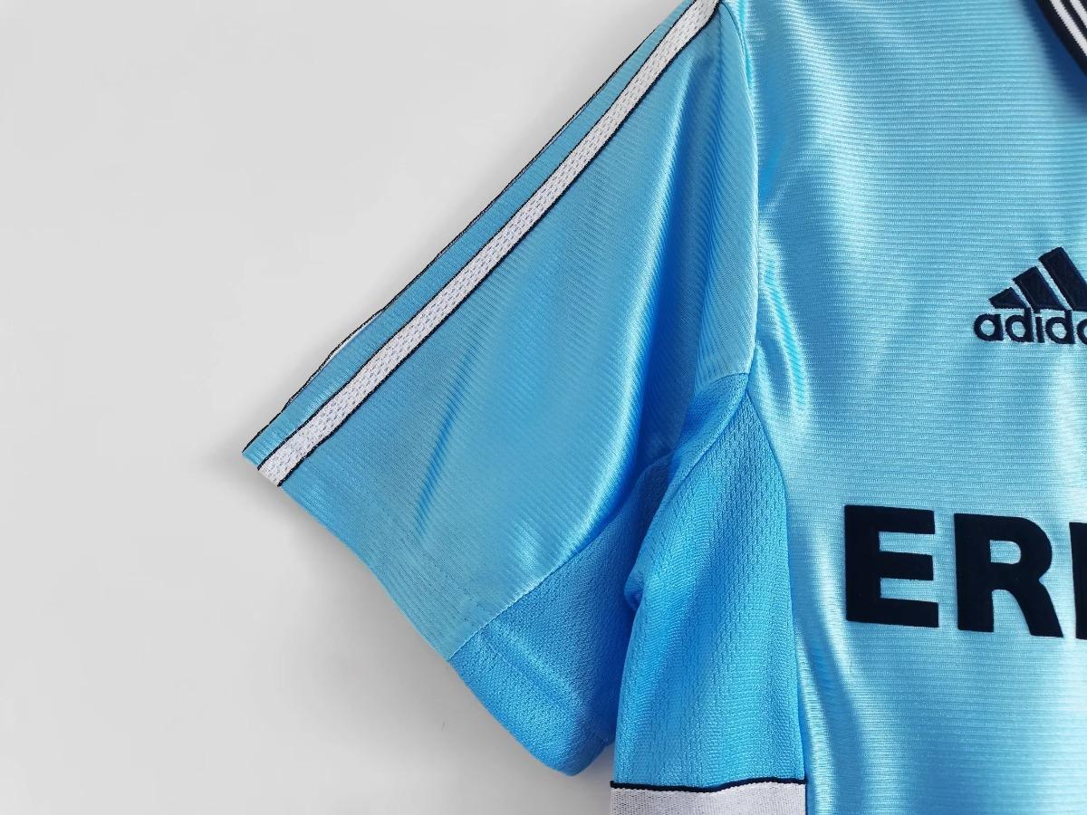Sky blue soccer jersey side detail with adidas shoulder stripe and part of ERICSSON