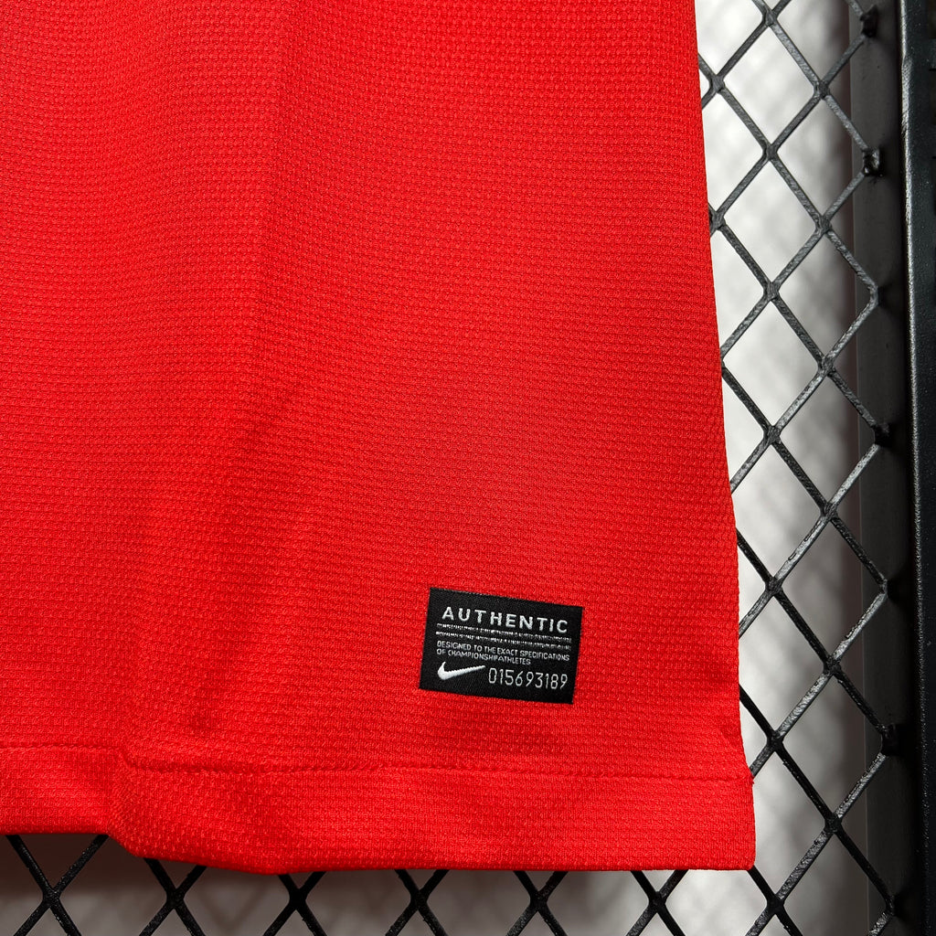 Red jersey hem close-up with Authentic label patch