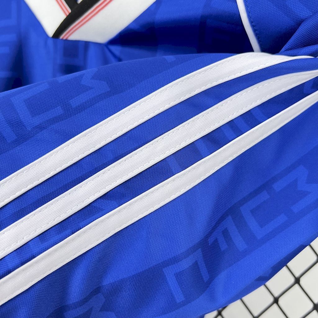Blue football shirt sleeve with white adidas triple stripes