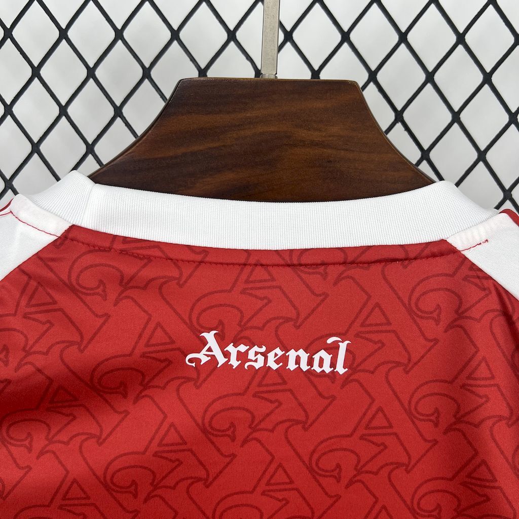 Red football shirt back with white ribbed collar and Arsenal lettering