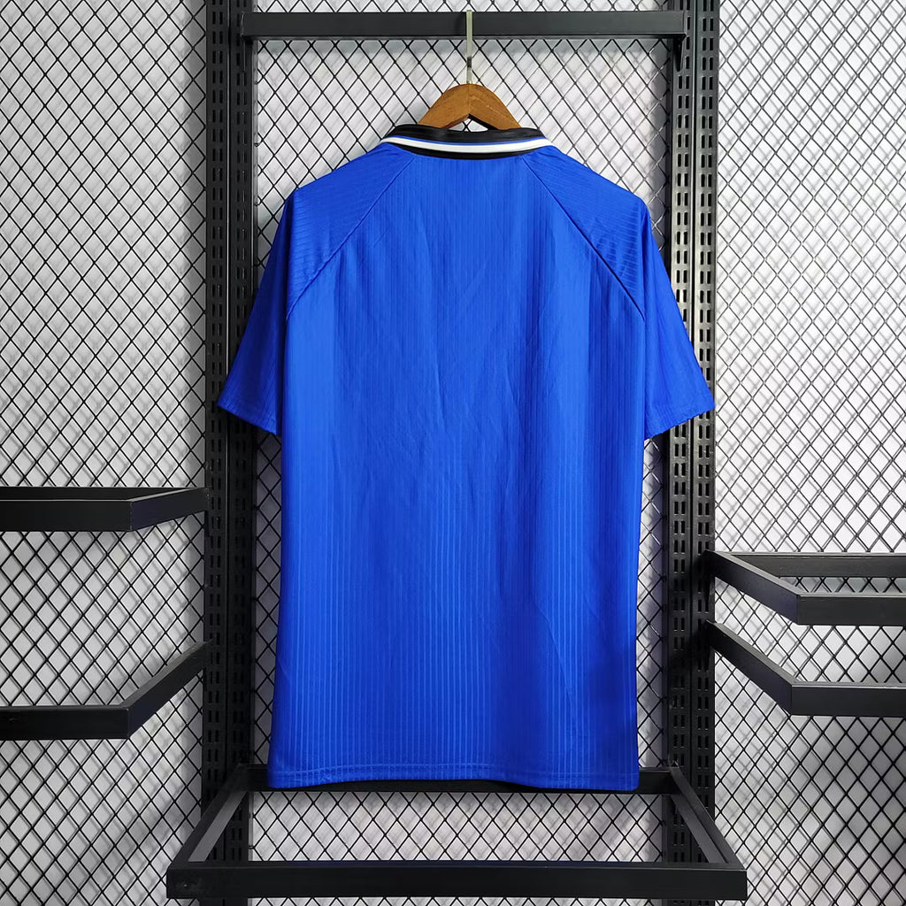 Blue retro soccer jersey back view with black collar and white neck trim