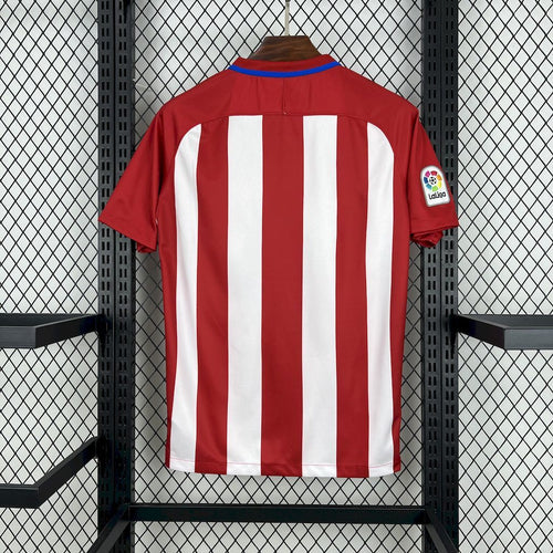 Red and white striped soccer jersey with blue crew collar and right-sleeve patch