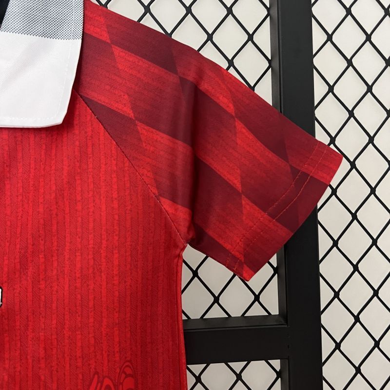 Red jersey with checkered shoulder panels and diagonal stripe design for kids