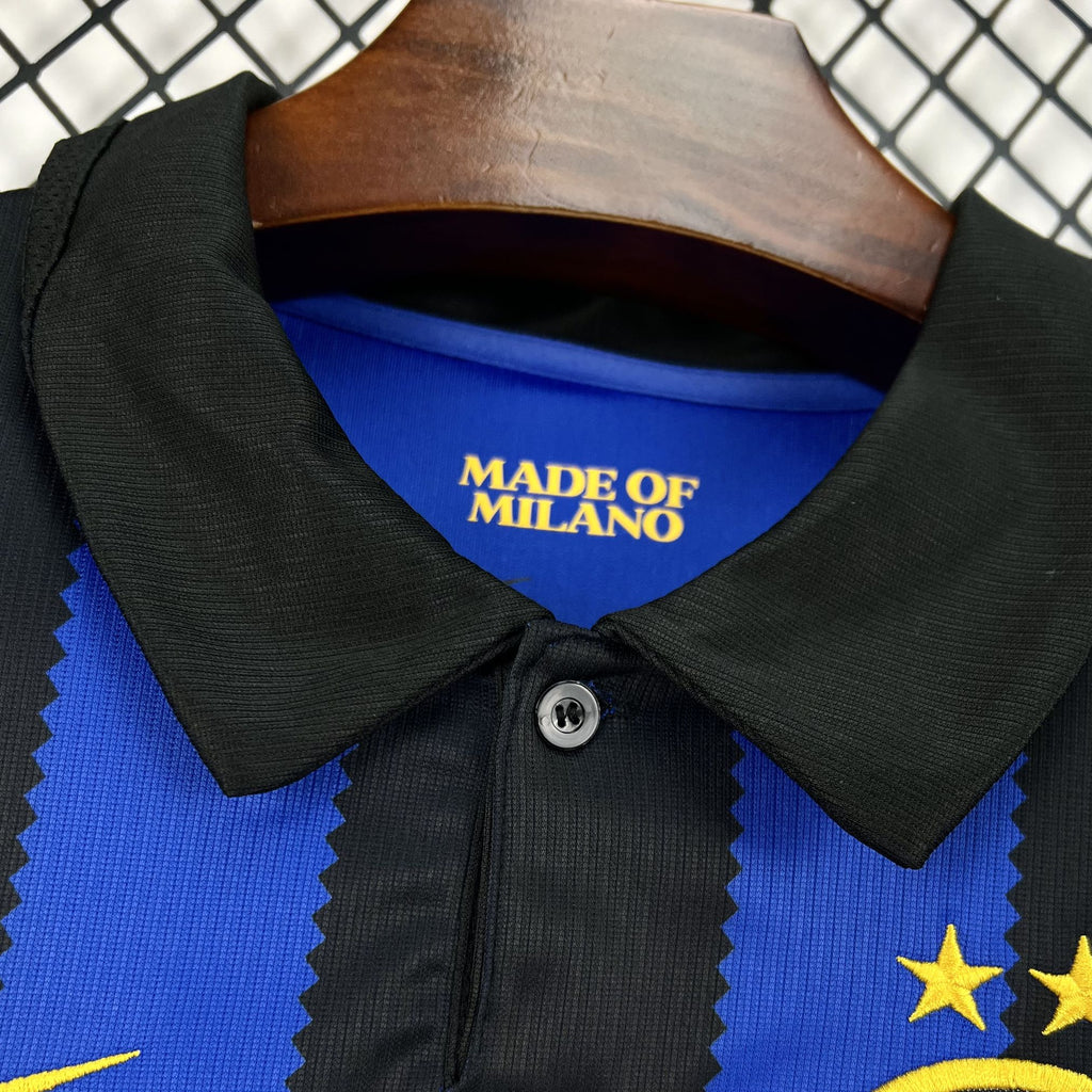 Football jersey collar close-up, black trim with snap button and Made of Milano label